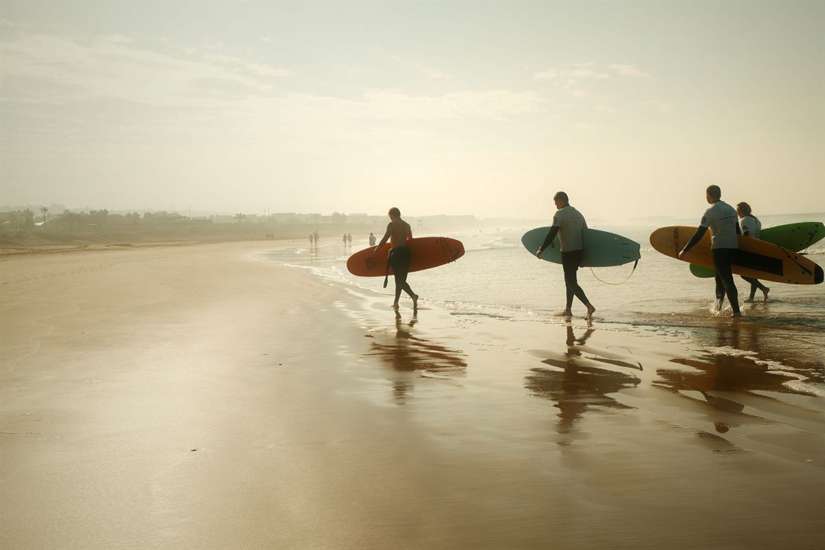 Group of surfers heading to the beach at a Taghazout surf camp