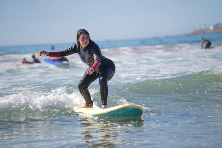 Surfer riding a wave during a surf lesson in Taghazout