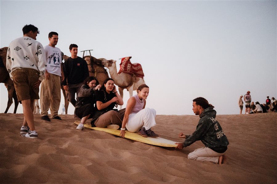 Rider on a sandboard on Taghazout desert dunes