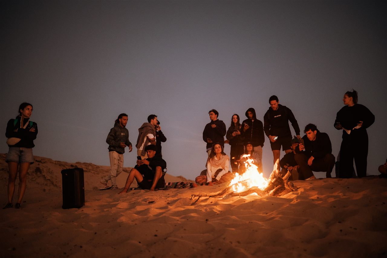Evening campfire on the sand dunes near Taghazout after a sandboarding session