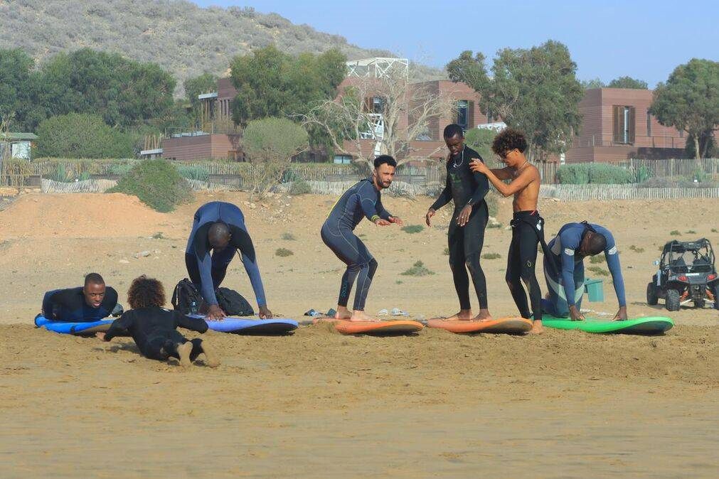 Local surf instructor with a happy student after a lesson in Taghazout